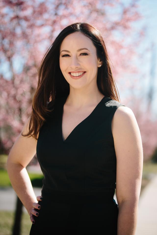 Portrait of Mrs. April Parreco standing on the terrace of the U.S. Naval Institute